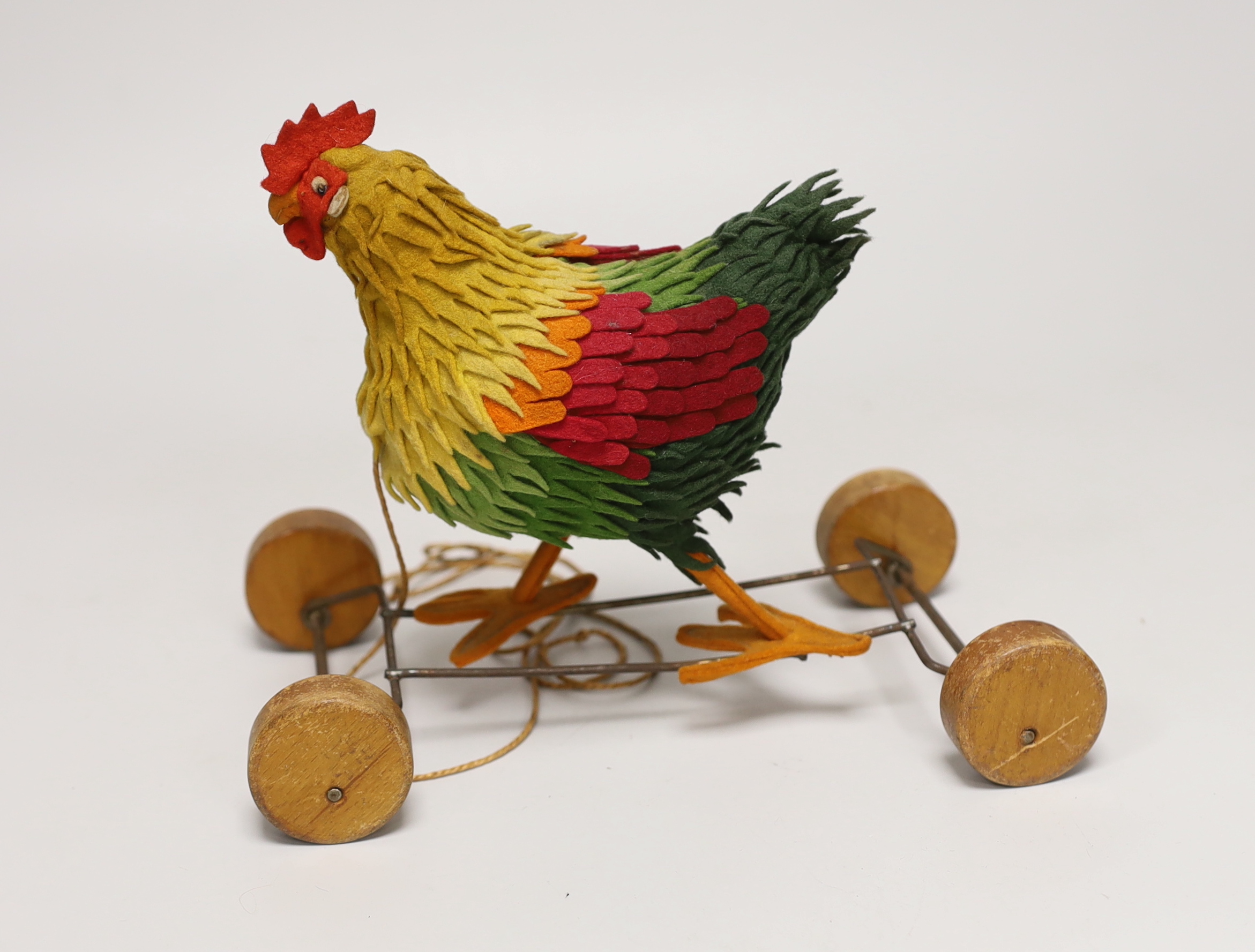 A Steiff cockerel on wooden wheel, c.1915, no button, good condition